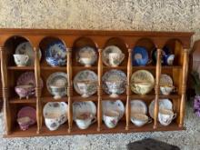 Walnut wall display case with 24 cups and saucers (1 CUP IS THE PUBLIC HIGH SCHOOL IN MANILLA, IA