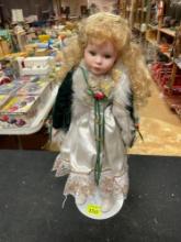 Vintage Porcelain Little Girl Doll with White, Green, and Gold Outfit and Stand