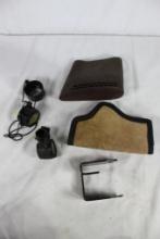 One OEM Ruger 10/22 lock bracket, one soft leather inside belt clip holster, one rubber slip-on butt