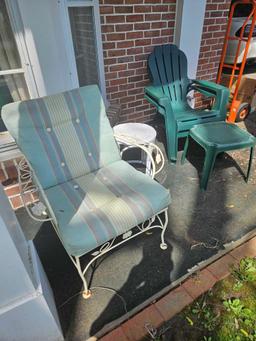 Lawn chairs and side tables on porch.