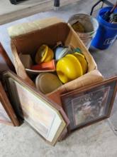 Box of Tupperware and framed pictures.