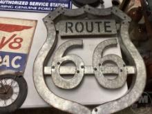 A TABLE WITH VARIOUS SIZED SIGNS, CLOCKS, ART, HARMONIC BALANCER