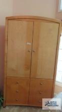 Light wood television cabinet with drawers