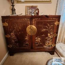 Oriental style cabinet with metal hinges and latch