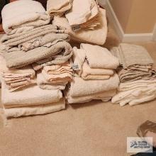Lot of light colored towels, washcloth, and hand towels