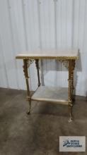 Antique ornate metal table with marble inserts and carvings. Also has glass ball and metal and