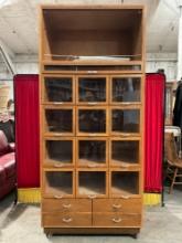 Antique 1900s Wheeled Wooden Haberdashers's Store Cabinet w/ 12 Display Cubbies & 5 Drawers. See