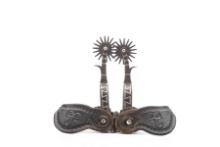 Pair of single mounted Spurs attributed to A. Buermann with silver inlay on heel bands and shanks, 2