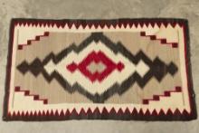 1940s Navajo Rug with brown, tan, cream and red colors. Measures 3 ft. x 5 ft. Very good condition w
