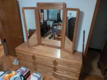 (BR2) OAK GRAIN NINE DRAWER DRESSER WITH TRIFOLD MIRROR. IT MEASURES 72-1/4"W X 18-1/2"D X 30"T TO