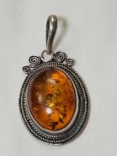 Sterling Silver Baltic Amber Oval Pendant. Marked 925. 10.0 grams....Measurement in pics.