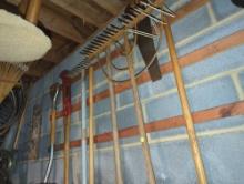 (GAR) WALL LOT OF MISC HAND TOOLS, SAWS, RAKES, PITCH FORK, ETC