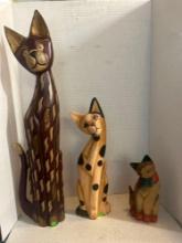 three decorative carved wooden cats
