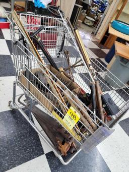 Cart full of vintage tools: hatchets, saws, wrenches, metal detector