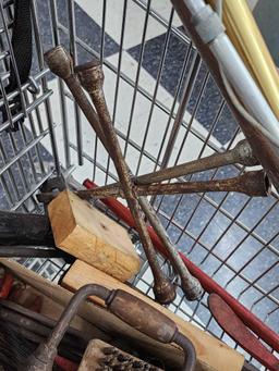 Cart full of vintage tools: hatchets, saws, wrenches, metal detector