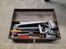 Metal tool box with assorted carpeting tools