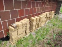 Groups of stacked pavers and bricks