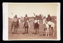 PHOTOGRAPH OF 4 MOUNTED INDIAN BRAVES.